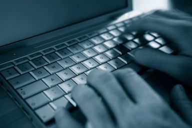 Hands typing on a keyboard